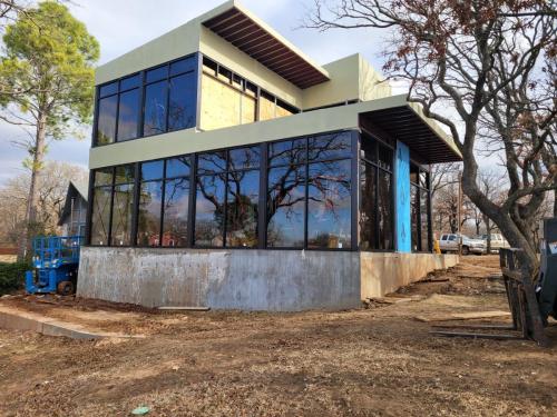 construction-process-stages-concrete-forms-steel-framing-steel-erection-two-story-floor-to-ceiling-windows-suspended-stairs-floating-staircase