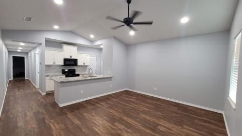 interior-duplex-construction-vinyl-floor-drywall-living-room-kitchen-hallway-open-concept