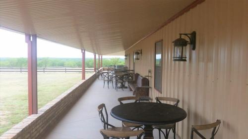 rustic--barn-metal-steel-building-building-wrap-around-porch-tables